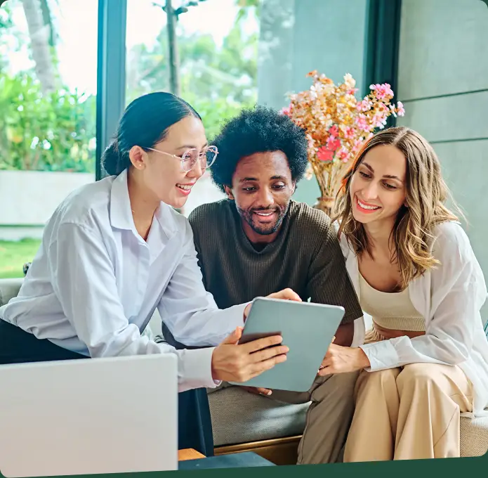 Three people review some documents